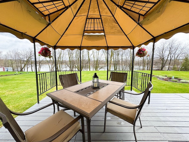 sunroom with outdoor dining space and a water view