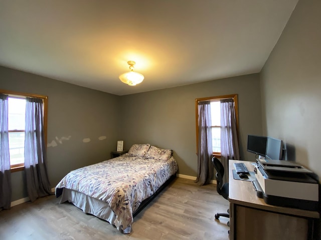 bedroom with baseboards and light wood-style floors