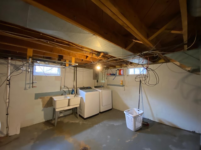below grade area featuring a sink and washing machine and dryer