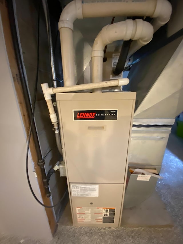 utility room featuring heating unit