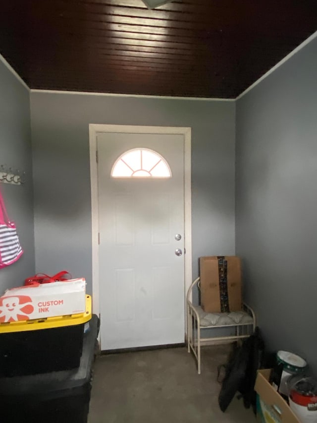 carpeted entrance foyer with wood ceiling