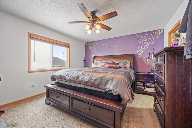 carpeted bedroom featuring baseboards, a ceiling fan, and a textured ceiling