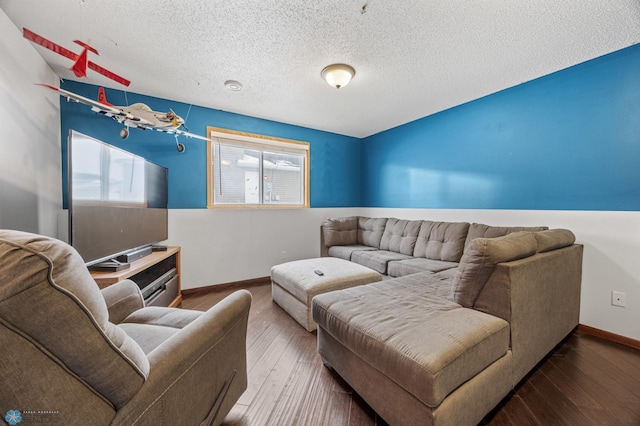 living room with baseboards, a textured ceiling, and wood finished floors
