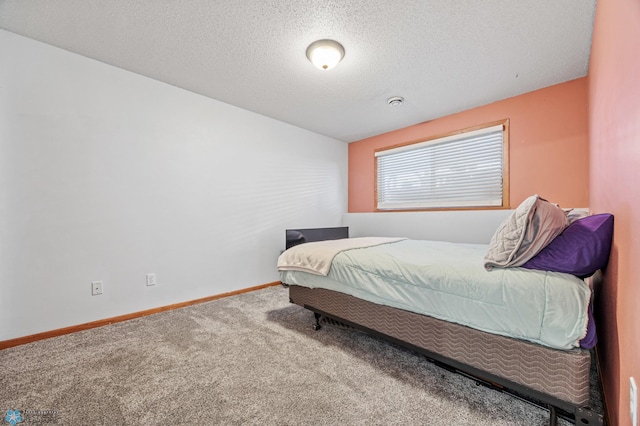 bedroom featuring carpet floors, a textured ceiling, and baseboards