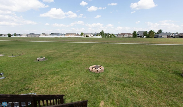surrounding community with a yard and a residential view