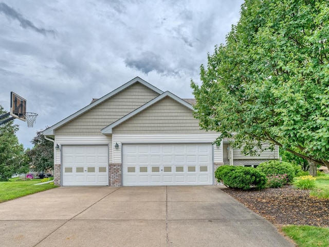 8918 Prestwick Pkwy N, Brooklyn Park, MN 55443 - view of front of property featuring brick siding, concrete driveway, and a garage