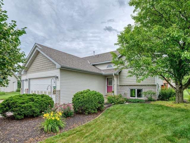 8918 Prestwick Pkwy N, Brooklyn Park, MN 55443 - tri-level home featuring a garage, a front lawn, a shingled roof, and brick siding