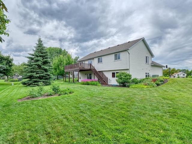 8918 Prestwick Pkwy N, Brooklyn Park, MN 55443 - back of property with stairway, a deck, and a yard