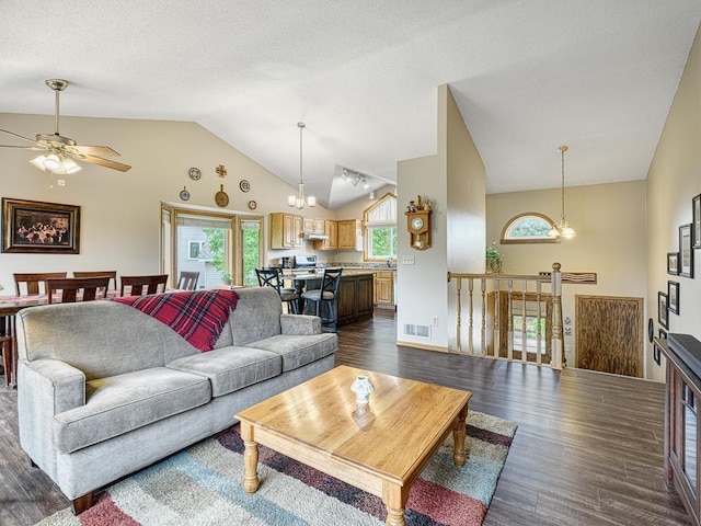 8918 Prestwick Pkwy N, Brooklyn Park, MN 55443 - living area featuring dark wood finished floors, high vaulted ceiling, ceiling fan, and a chandelier