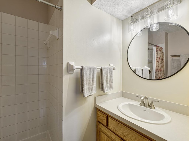 8918 Prestwick Pkwy N, Brooklyn Park, MN 55443 - bathroom with a textured ceiling, vanity, and tiled shower