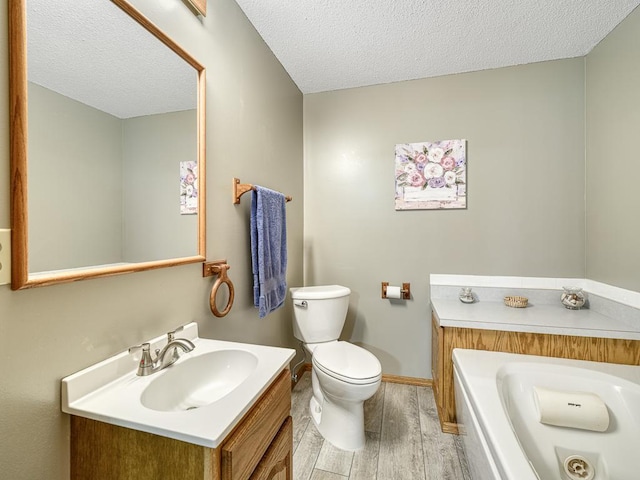 8918 Prestwick Pkwy N, Brooklyn Park, MN 55443 - full bathroom with wood finished floors, a textured ceiling, vanity, and a garden tub