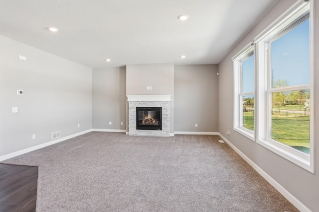 8441 152nd Ln NW, Ramsey, MN 55303 - unfurnished living room featuring a fireplace, baseboards, recessed lighting, and carpet flooring