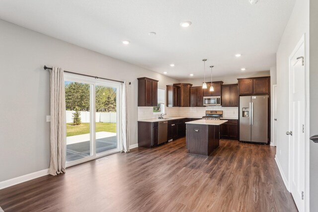 8441 152nd Ln NW, Ramsey, MN 55303 - kitchen featuring appliances with stainless steel finishes, dark brown cabinetry, a sink, light countertops, and recessed lighting
