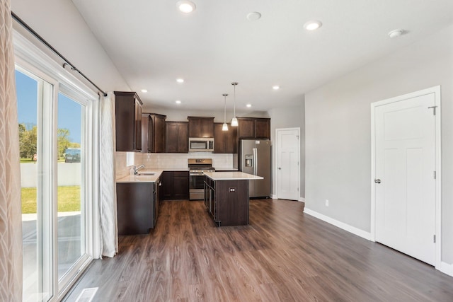 8441 152nd Ln NW, Ramsey, MN 55303 - kitchen with stainless steel appliances, dark brown cabinetry, light countertops, baseboards, and dark wood finished floors