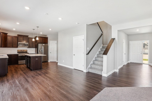 8441 152nd Ln NW, Ramsey, MN 55303 - kitchen featuring stainless steel appliances, open floor plan, light countertops, a kitchen island, and dark brown cabinetry