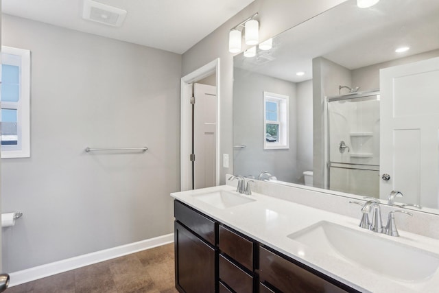 8441 152nd Ln NW, Ramsey, MN 55303 - full bathroom featuring toilet, baseboards, a shower stall, and double vanity