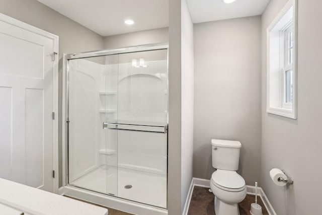 8441 152nd Ln NW, Ramsey, MN 55303 - bathroom featuring toilet, baseboards, and a shower stall