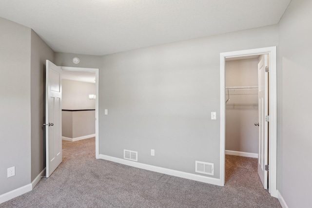 8441 152nd Ln NW, Ramsey, MN 55303 - unfurnished bedroom with a spacious closet, light colored carpet, baseboards, and a closet