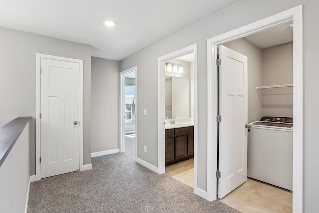 8441 152nd Ln NW, Ramsey, MN 55303 - hall featuring washer / clothes dryer, light colored carpet, baseboards, a sink, and recessed lighting