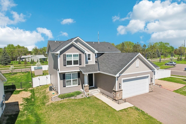 8441 152nd Ln NW, Ramsey, MN 55303 - view of front of home with an attached garage, driveway, a shingled roof, stone siding, and a gate
