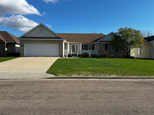 ranch-style home with an attached garage, driveway, a front yard, and covered porch