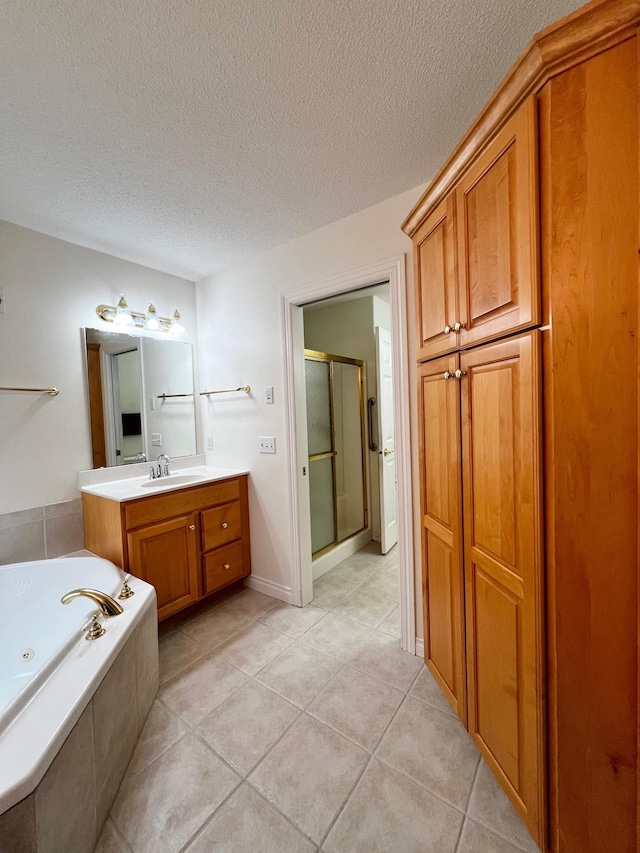 full bath featuring vanity, a textured ceiling, tile patterned floors, a whirlpool tub, and a shower stall