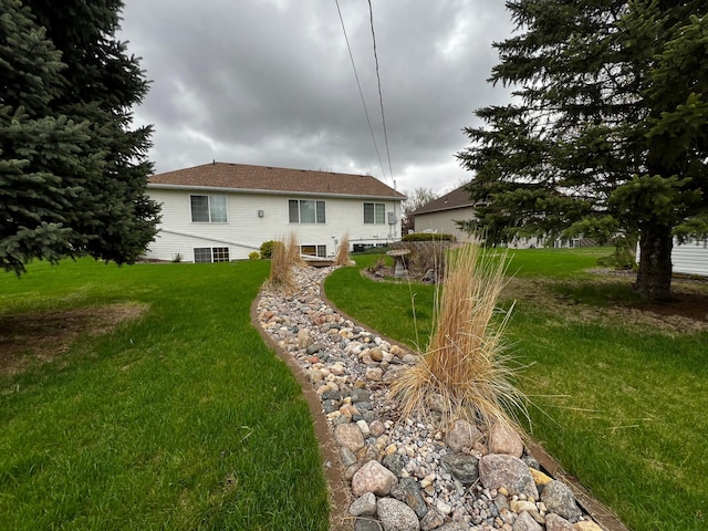 rear view of property with a lawn and central air condition unit
