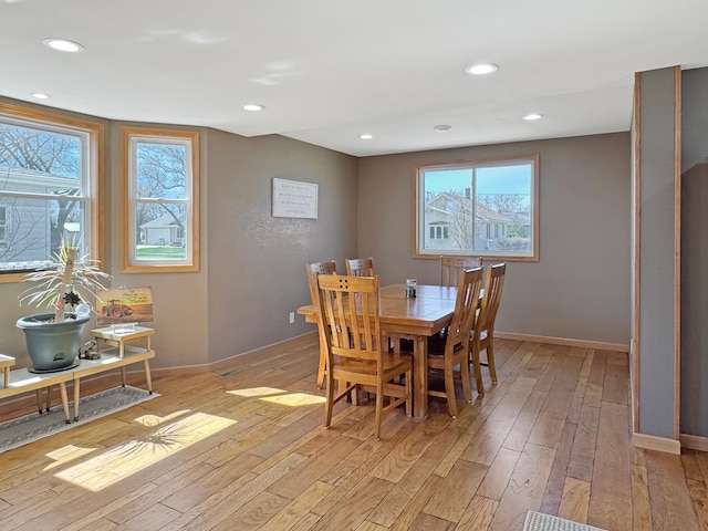 dining area with recessed lighting, baseboards, and light wood finished floors