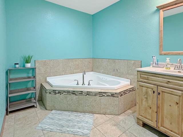 full bathroom with tile patterned floors, a bath, and vanity