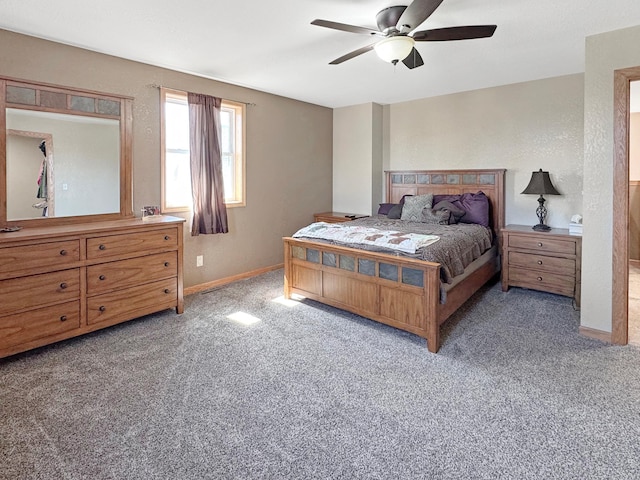 bedroom featuring baseboards, ceiling fan, and light carpet