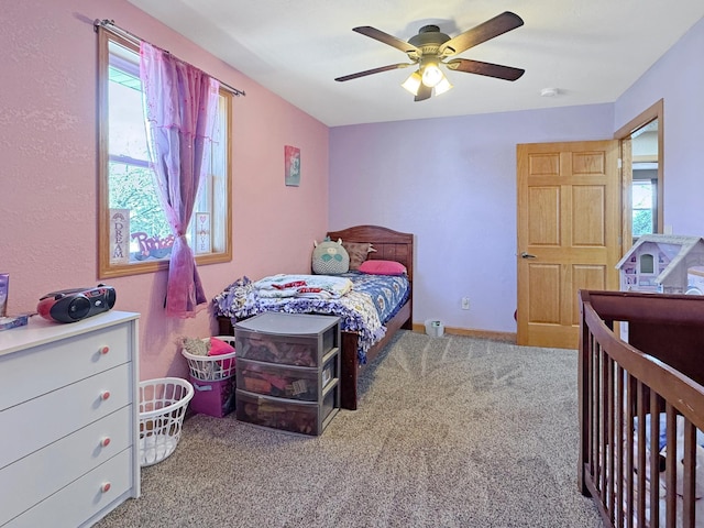 carpeted bedroom with baseboards and ceiling fan