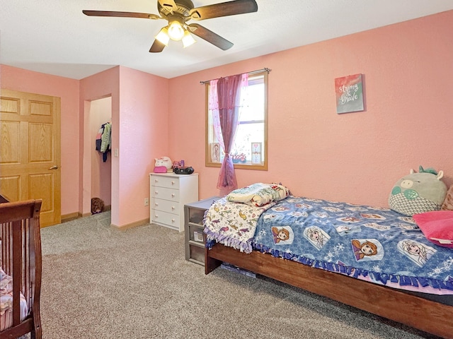 carpeted bedroom with baseboards and ceiling fan