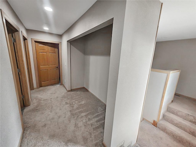 hallway featuring recessed lighting, carpet, and stairs