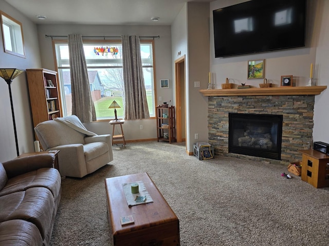 living room featuring plenty of natural light, a fireplace, baseboards, and carpet floors
