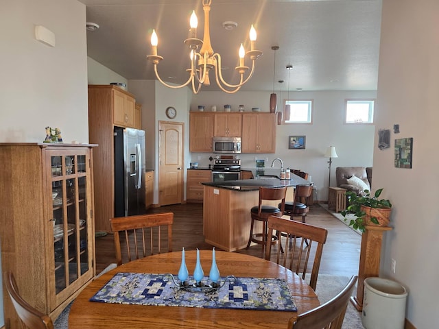 dining area with baseboards, dark wood finished floors, and an inviting chandelier