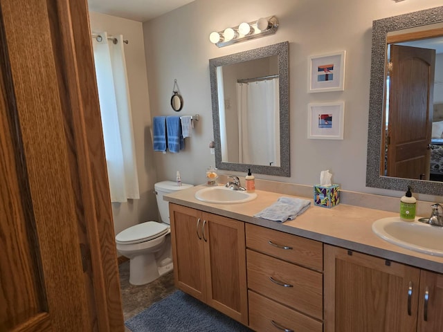 full bathroom featuring a sink, double vanity, and toilet