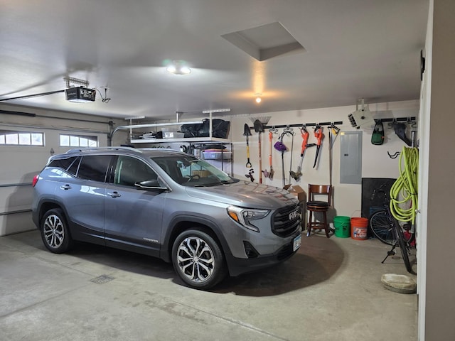 garage featuring electric panel and a garage door opener