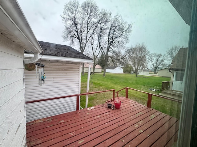 wooden deck featuring a lawn