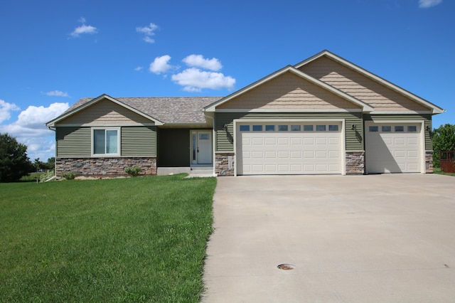1052 Hidden Ln, New Richmond, WI 54017 - craftsman house featuring concrete driveway, a front yard, an attached garage, and stone siding