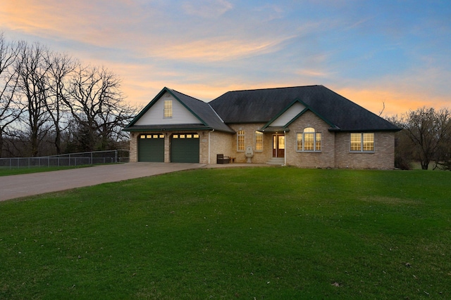 view of front of property with a lawn, fence, driveway, and brick siding