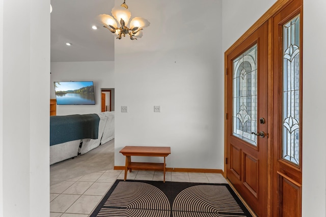 foyer entrance featuring light colored carpet, an inviting chandelier, light tile patterned flooring, and recessed lighting