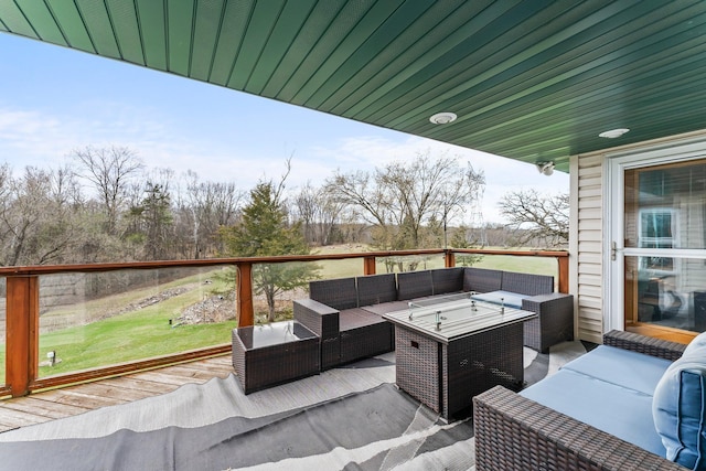 wooden terrace with an outdoor living space