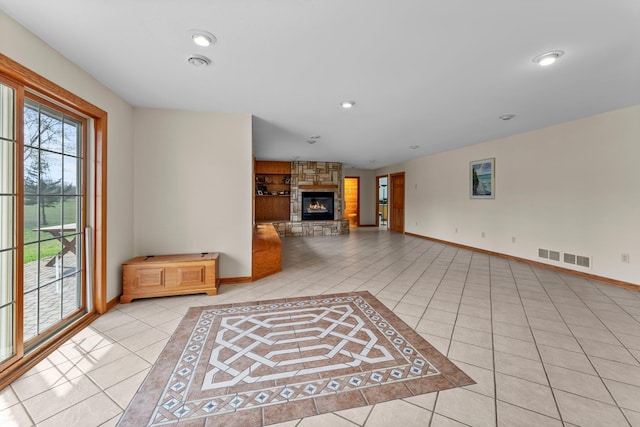 unfurnished living room with visible vents, baseboards, a stone fireplace, recessed lighting, and light tile patterned floors