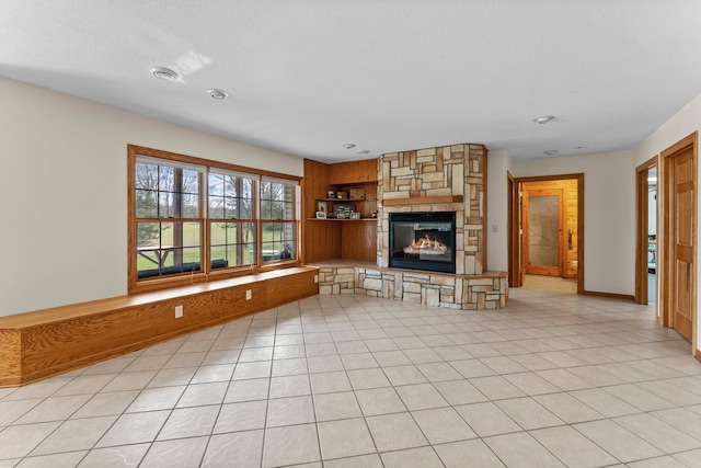 unfurnished living room with baseboards and a fireplace