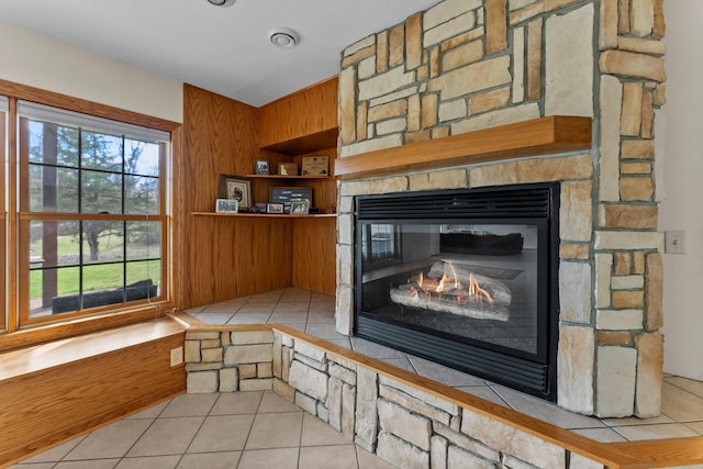 room details featuring wooden walls and a fireplace