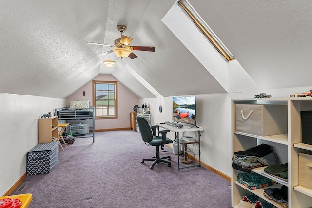 office space with lofted ceiling, baseboards, a textured ceiling, a ceiling fan, and carpet