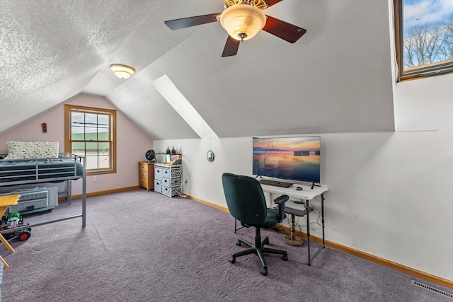 carpeted office space featuring baseboards, a ceiling fan, vaulted ceiling, and a textured ceiling