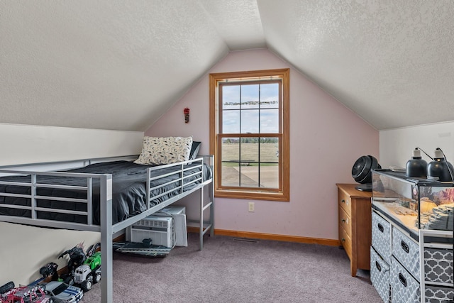 bedroom with baseboards, carpet flooring, a textured ceiling, and vaulted ceiling