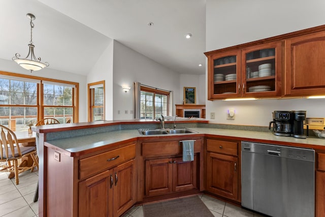 kitchen featuring a peninsula, light tile patterned flooring, a sink, dishwasher, and vaulted ceiling