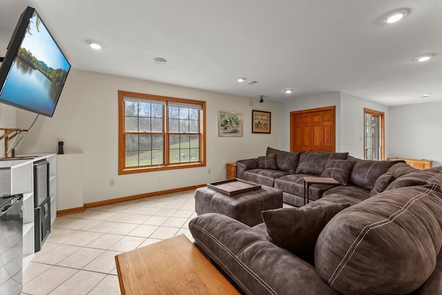 living area featuring baseboards, recessed lighting, and light tile patterned flooring